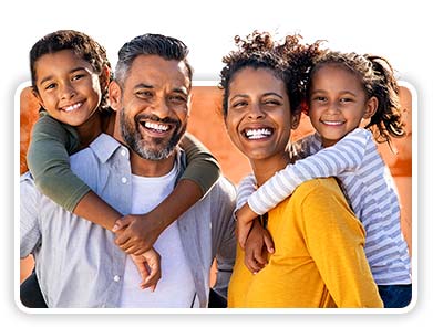 Happy family of four. Find life insurance.